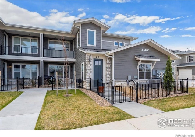 350 High Point Dr Unit 201, Longmont, CO 80504 - townhome / multi-family property featuring stone siding and a gate