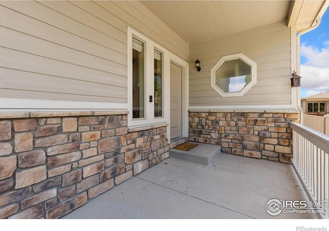 entrance to property featuring stone siding