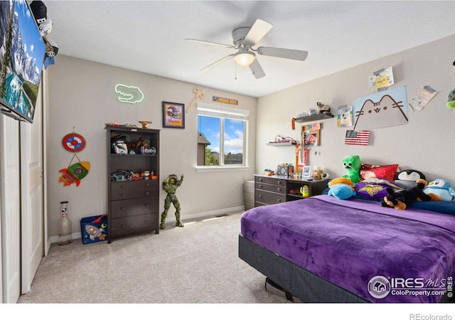 bedroom with carpet, a ceiling fan, and baseboards