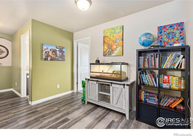 interior space featuring wood finished floors and baseboards