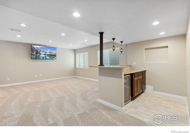 kitchen with recessed lighting, baseboards, wine cooler, light carpet, and light stone countertops