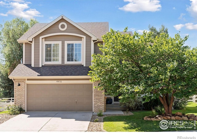 4416 Pika Dr, Loveland, CO 80537 - view of front facade featuring driveway, brick siding, an attached garage, and a shingled roof