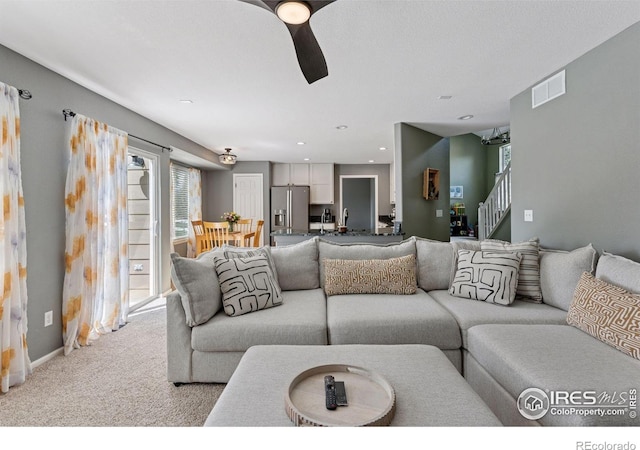 4416 Pika Dr, Loveland, CO 80537 - living area with ceiling fan, stairs, and light colored carpet