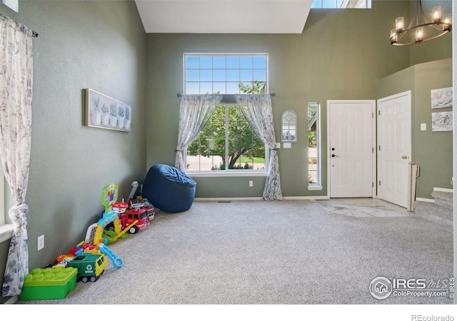 4416 Pika Dr, Loveland, CO 80537 - carpeted entryway featuring a chandelier, healthy amount of natural light, baseboards, and a towering ceiling
