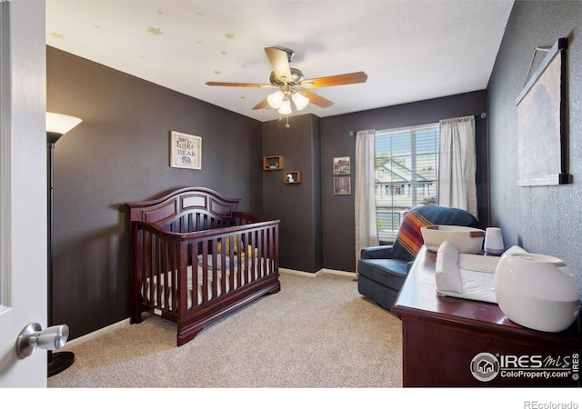 4416 Pika Dr, Loveland, CO 80537 - carpeted bedroom with a nursery area, a ceiling fan, and baseboards