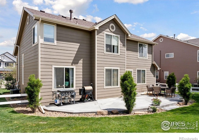 4416 Pika Dr, Loveland, CO 80537 - rear view of property featuring a patio area, a lawn, and central AC