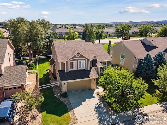4416 Pika Dr, Loveland, CO 80537 - view of front of house with a residential view, brick siding, concrete driveway, an attached garage, and a shingled roof