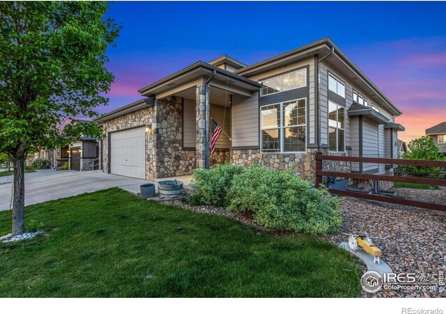 2119 Pelican Farm Rd, Windsor, CO 80550 - view of front of home with stone siding, driveway, and a garage