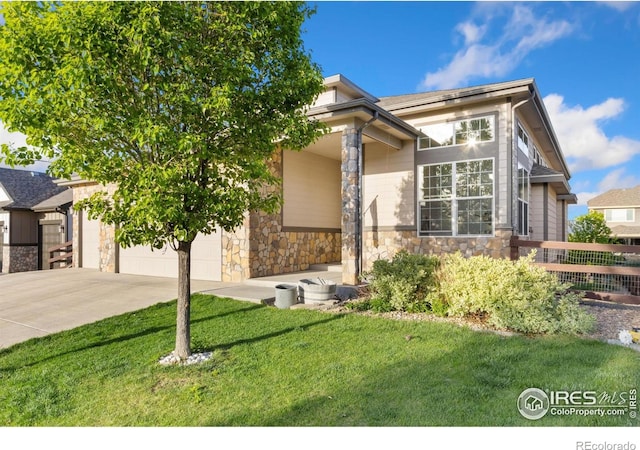 2119 Pelican Farm Rd, Windsor, CO 80550 - view of front of house featuring stone siding, driveway, a front lawn, and an attached garage