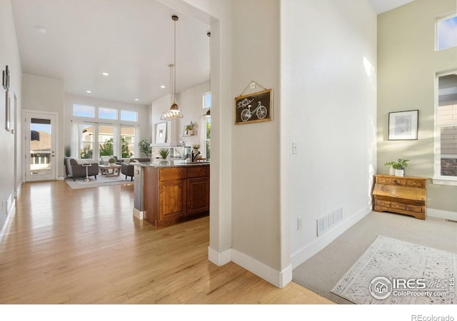 2119 Pelican Farm Rd, Windsor, CO 80550 - hallway with light wood-style floors, baseboards, recessed lighting, and a towering ceiling