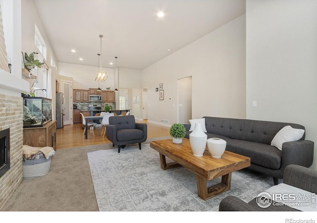 2119 Pelican Farm Rd, Windsor, CO 80550 - living room with a fireplace, recessed lighting, and light colored carpet