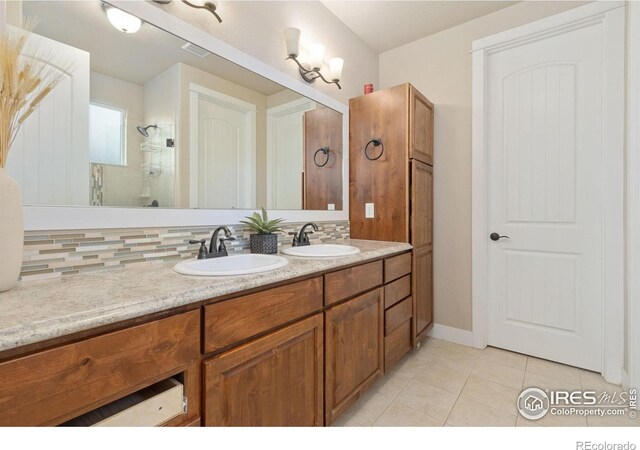 2119 Pelican Farm Rd, Windsor, CO 80550 - bathroom featuring tile patterned floors, double vanity, a shower, and baseboards
