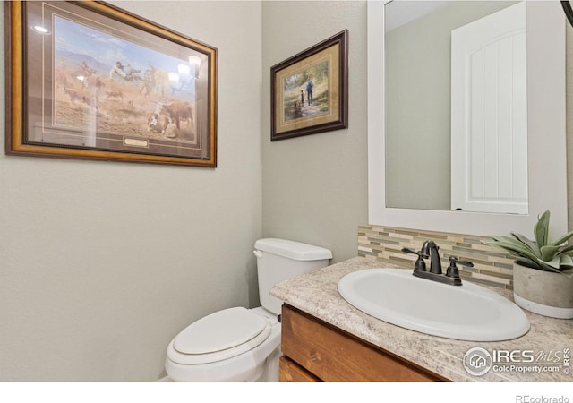 2119 Pelican Farm Rd, Windsor, CO 80550 - bathroom with decorative backsplash, toilet, and vanity
