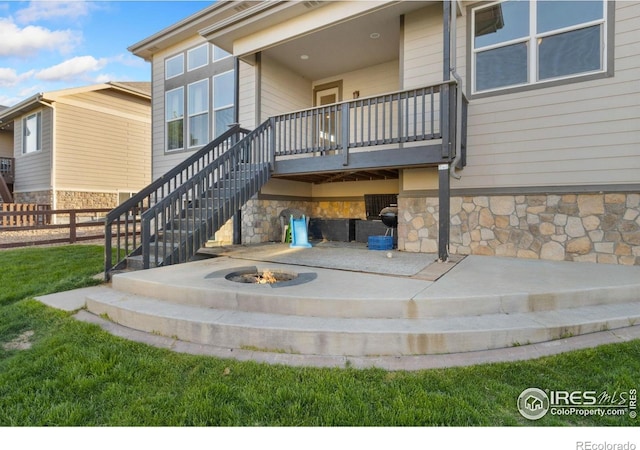 2119 Pelican Farm Rd, Windsor, CO 80550 - back of house with stone siding, stairs, and a fire pit