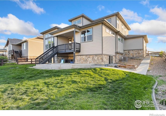 2119 Pelican Farm Rd, Windsor, CO 80550 - rear view of property with stone siding, central AC, and stairway
