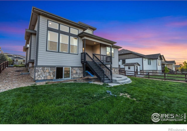 2119 Pelican Farm Rd, Windsor, CO 80550 - rear view of property with stairway, stone siding, a storage unit, and an outbuilding