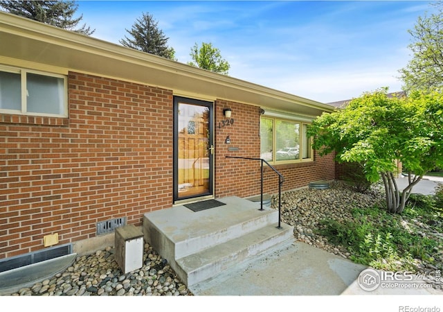 1320 Lory St, Fort Collins, CO 80524 - doorway to property featuring brick siding and crawl space