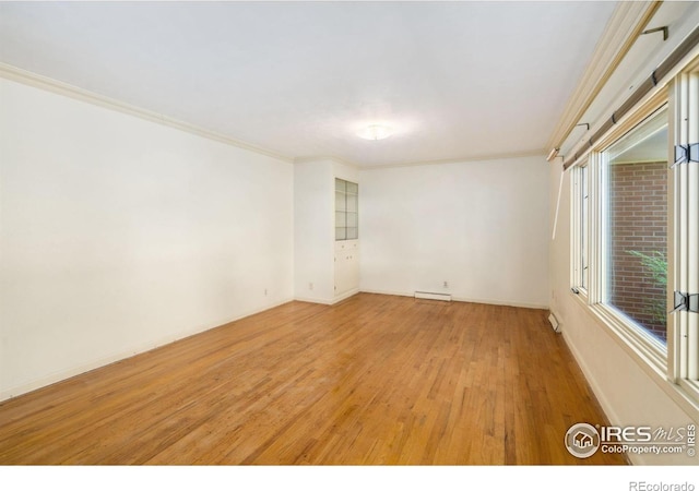1320 Lory St, Fort Collins, CO 80524 - empty room featuring ornamental molding, light wood-style flooring, baseboards, and baseboard heating