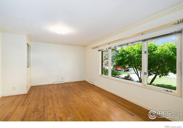 1320 Lory St, Fort Collins, CO 80524 - spare room with light wood-style flooring, baseboards, ornamental molding, and baseboard heating