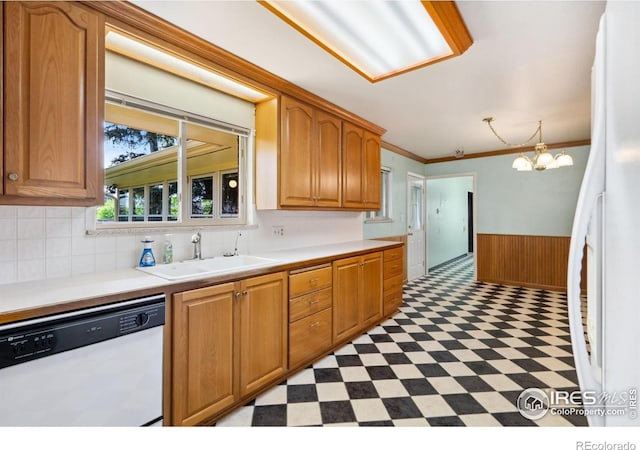 1320 Lory St, Fort Collins, CO 80524 - kitchen featuring white appliances, a sink, light flooring, light countertops, and a wainscoted wall