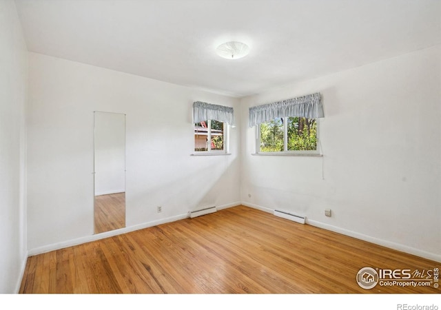 1320 Lory St, Fort Collins, CO 80524 - unfurnished room with baseboard heating, a baseboard radiator, wood finished floors, and baseboards