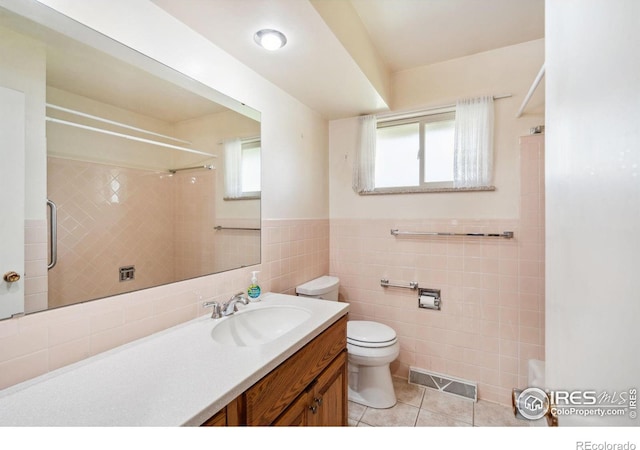 1320 Lory St, Fort Collins, CO 80524 - bathroom featuring toilet, tile walls, tile patterned floors, vanity, and a shower