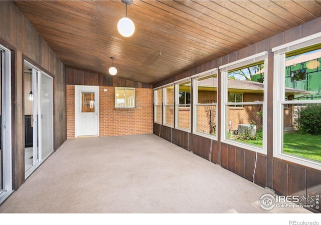 1320 Lory St, Fort Collins, CO 80524 - unfurnished sunroom with wood walls, wood ceiling, carpet, brick wall, and vaulted ceiling