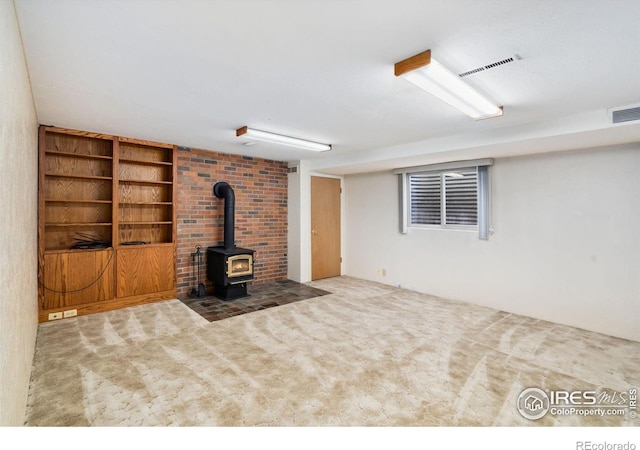 1320 Lory St, Fort Collins, CO 80524 - unfurnished living room featuring a wood stove, carpet floors, and built in shelves