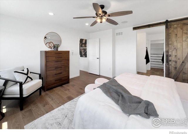 6506 Merrimack Dr, Castle Pines, CO 80108 - bedroom featuring a barn door, recessed lighting, wood finished floors, a ceiling fan, and baseboards