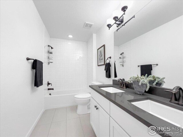 6506 Merrimack Dr, Castle Pines, CO 80108 - bathroom with tile patterned floors, toilet, tub / shower combination, double vanity, and baseboards