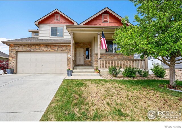 711 Mt Evans Ave, Severance, CO 80550 - craftsman inspired home featuring a porch, an attached garage, concrete driveway, a front yard, and stone siding