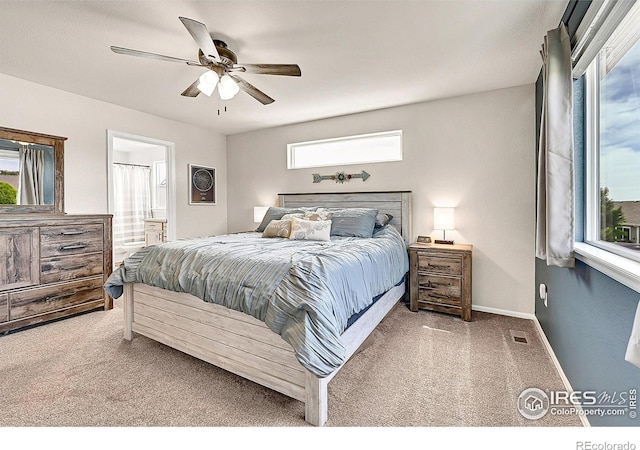 711 Mt Evans Ave, Severance, CO 80550 - carpeted bedroom with ensuite bathroom, a ceiling fan, and baseboards