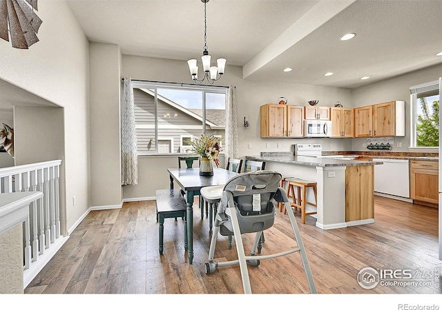 711 Mt Evans Ave, Severance, CO 80550 - dining area featuring light wood finished floors, a chandelier, recessed lighting, and baseboards