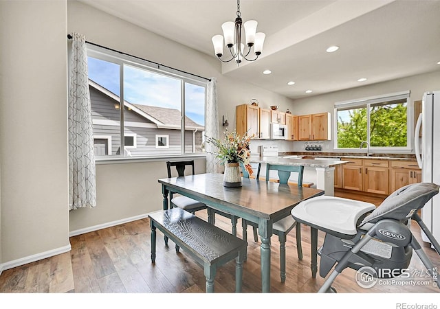 711 Mt Evans Ave, Severance, CO 80550 - dining space with a chandelier, wood finished floors, recessed lighting, and baseboards