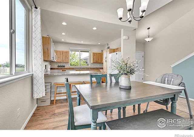 711 Mt Evans Ave, Severance, CO 80550 - dining room featuring recessed lighting, baseboards, a chandelier, and light wood finished floors