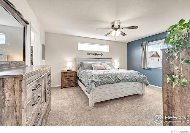 711 Mt Evans Ave, Severance, CO 80550 - bedroom with light colored carpet, baseboards, and ceiling fan