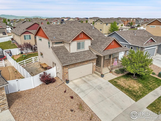 711 Mt Evans Ave, Severance, CO 80550 - craftsman house with a residential view, roof with shingles, concrete driveway, covered porch, and an attached garage
