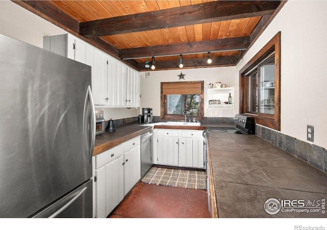 1824 Lazy Z Rd, Nederland, CO 80466 - kitchen featuring stainless steel appliances, wood ceiling, white cabinets, a sink, and beam ceiling