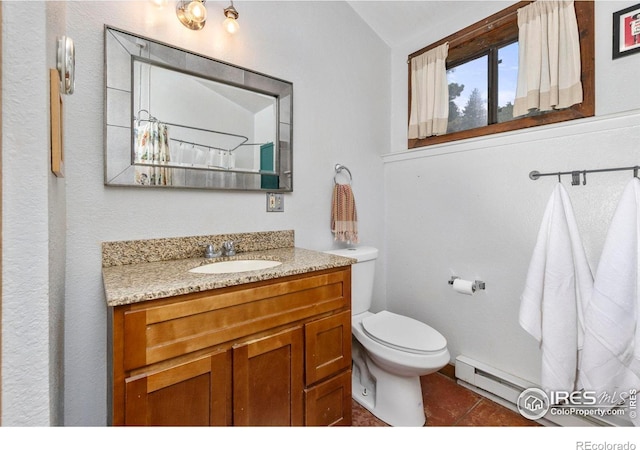 1824 Lazy Z Rd, Nederland, CO 80466 - bathroom featuring baseboard heating, toilet, tile patterned floors, vanity, and lofted ceiling