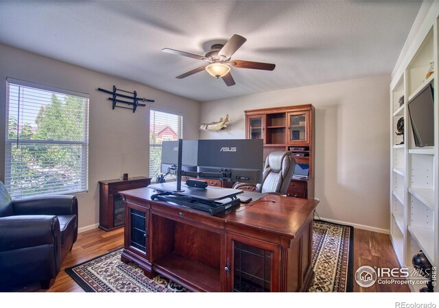 home office featuring ceiling fan, wood finished floors, and baseboards