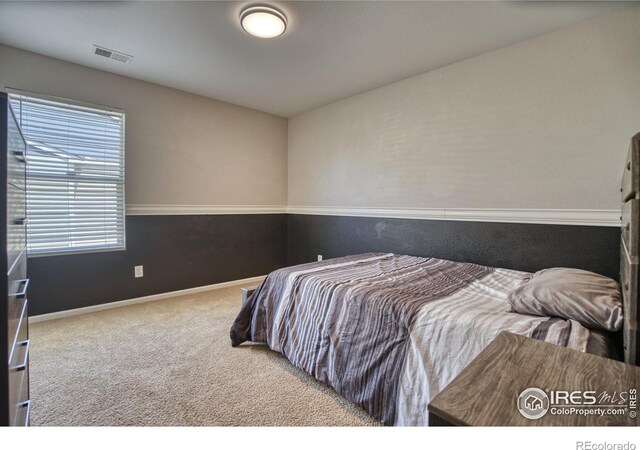 carpeted bedroom with baseboards