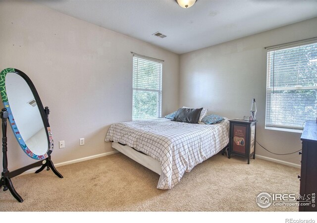 bedroom featuring carpet flooring and baseboards