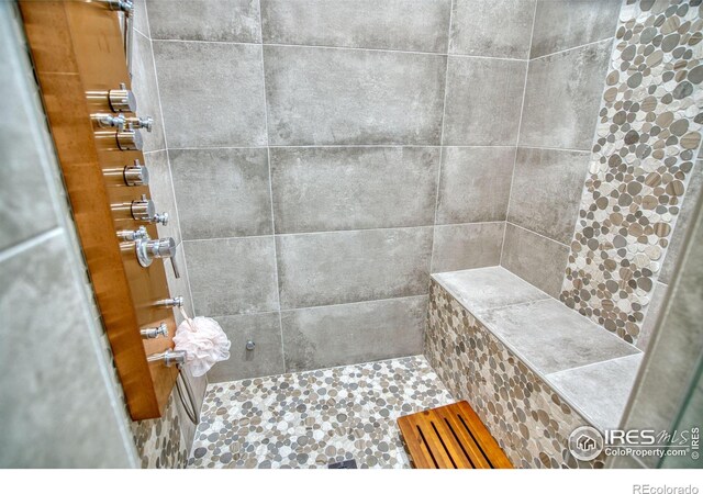 full bathroom with tiled shower