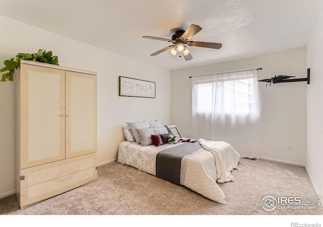 bedroom with carpet flooring, baseboards, and ceiling fan