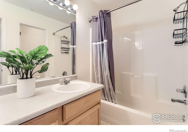 bathroom with shower / tub combo with curtain and vanity
