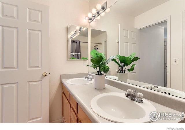 bathroom featuring double vanity