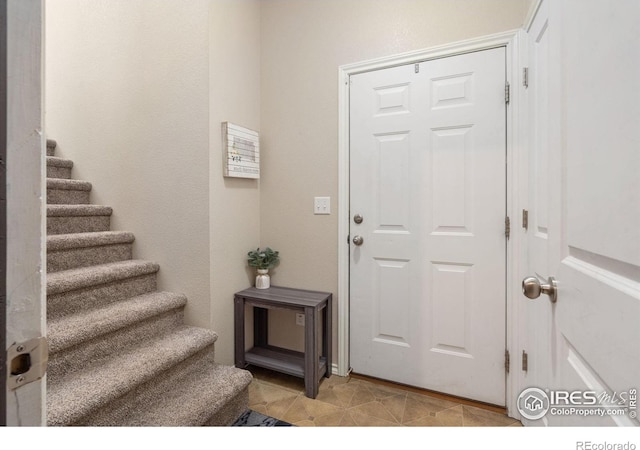 foyer featuring stairs