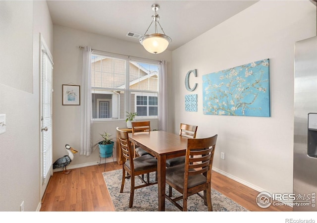 dining area with wood finished floors and baseboards