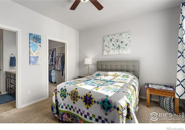 bedroom with carpet floors, a spacious closet, a closet, and baseboards