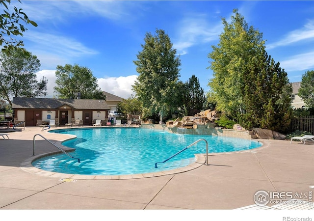 community pool featuring a patio and fence